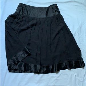 Black, pleated, A-line skirt.